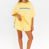 Yellow lounge shorts with drawstring waist and blue CW logo detail - pockets – front view