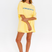 Yellow oversized lounge tee with blue CW logo – front view