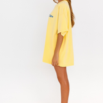 Yellow oversized lounge tee with blue CW logo – side view