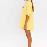 Yellow oversized lounge tee with blue CW logo – side view