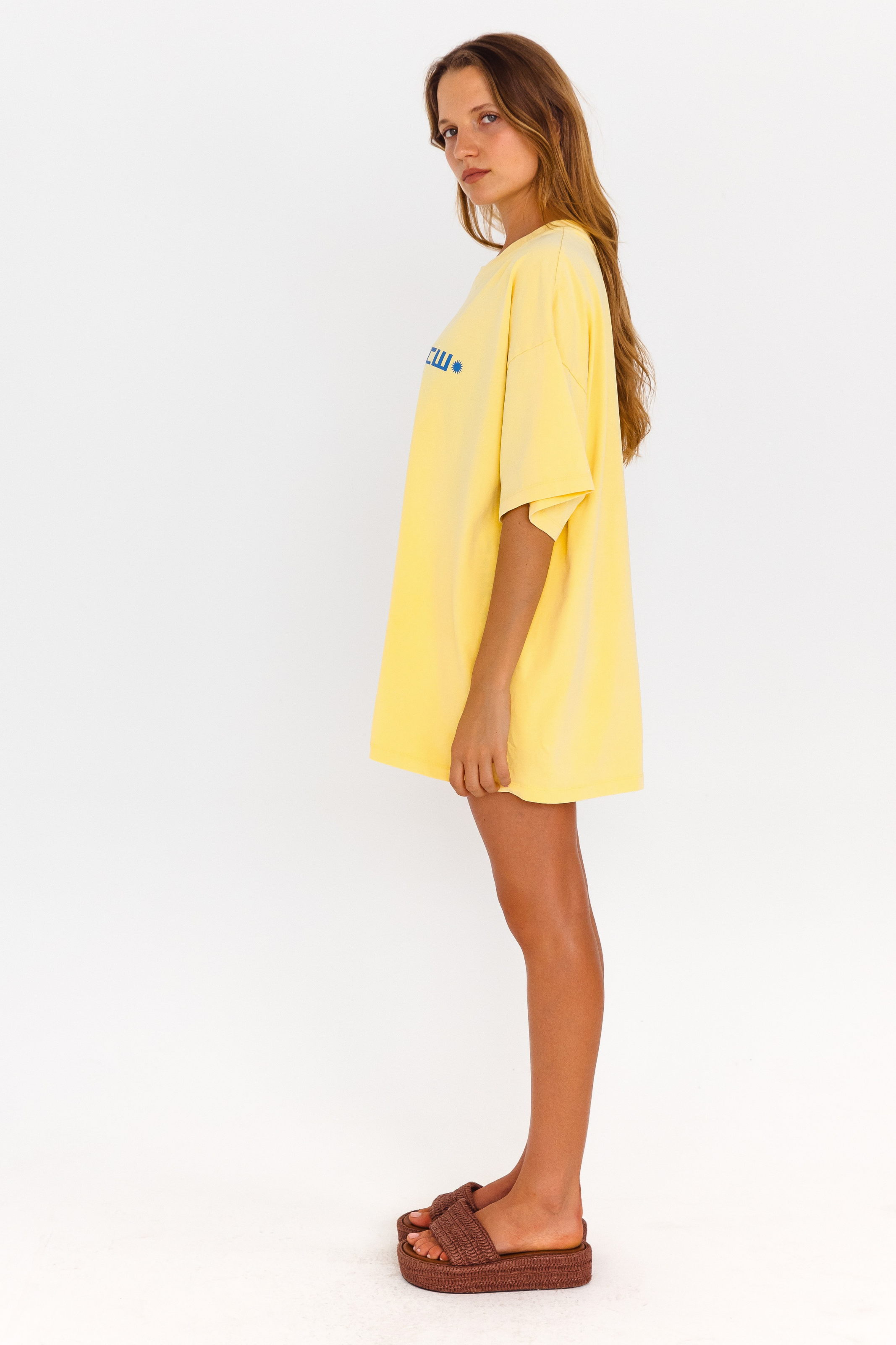 Yellow oversized lounge tee with blue CW logo – side view