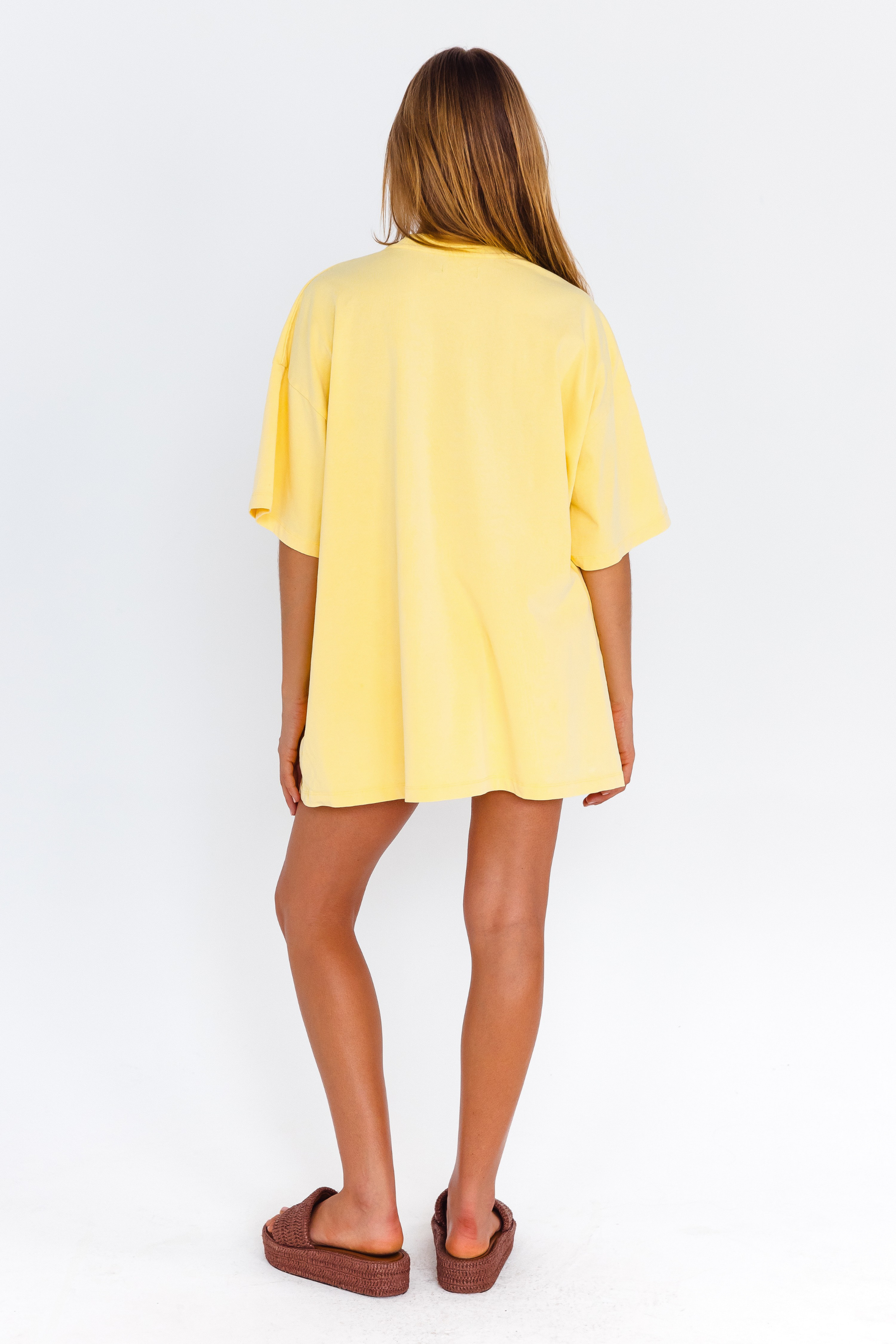 Yellow oversized lounge tee with blue CW logo – back view