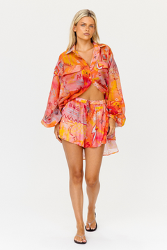 Pink and orange graphic print elastic waist shorts with drawstring and pockets – front view